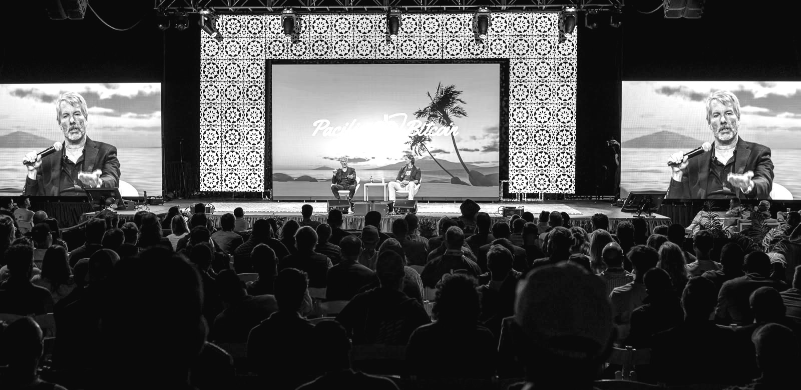 Michael Saylor in conversation on the Pacific Bitcoin main stage, shown on two giant screens above a packed audience.